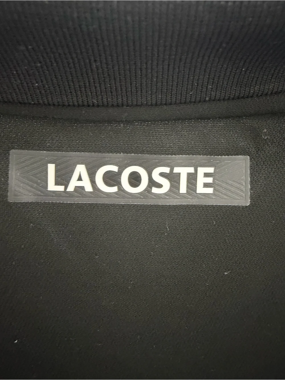 Lacoste Black Polo with Blue Panels and Green Accents